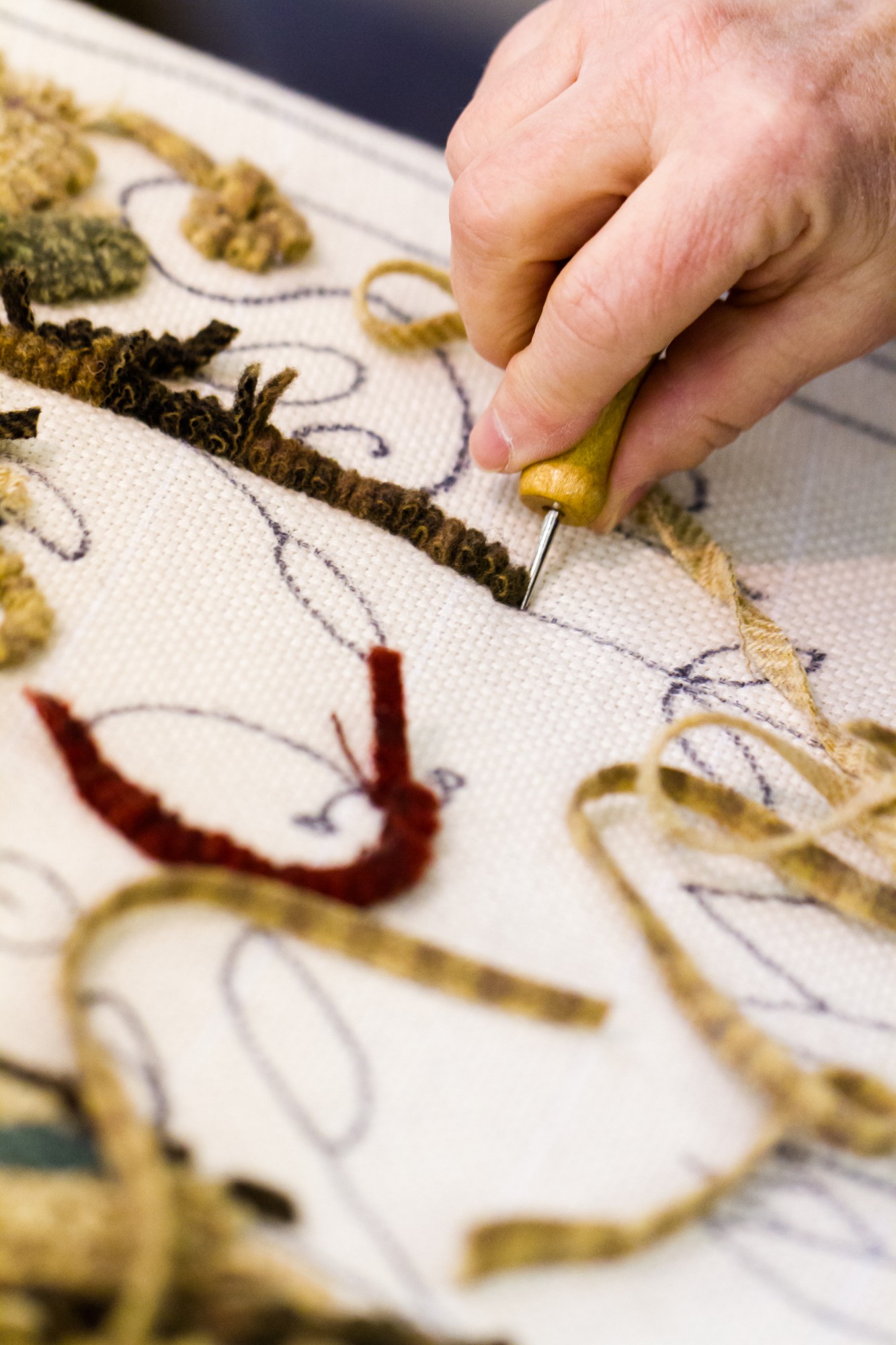 Large embroidered textile sample on backdrop